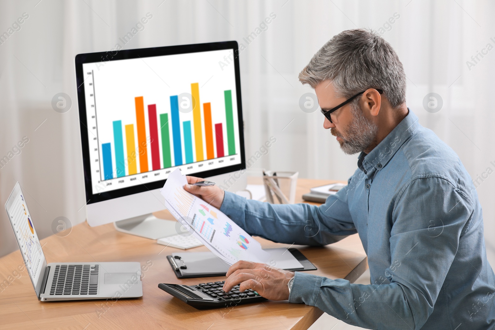 Photo of Professional accountant working at wooden desk in office