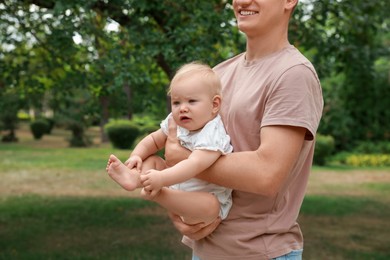 Photo of Father with his cute baby spending time together outdoors