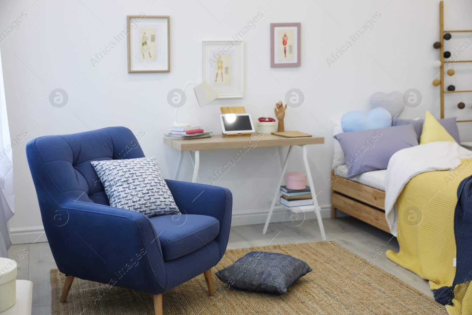 Photo of Modern teenager's room interior with bed and armchair