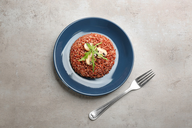 Photo of Delicious brown rice served on light table, flat lay