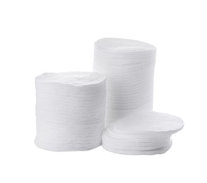 Photo of Stacks of clean cotton pads on white background