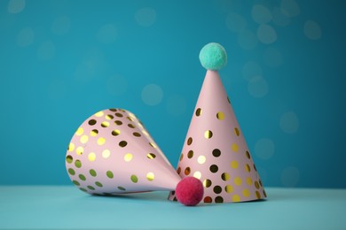 Photo of Beautiful party hats on light blue background