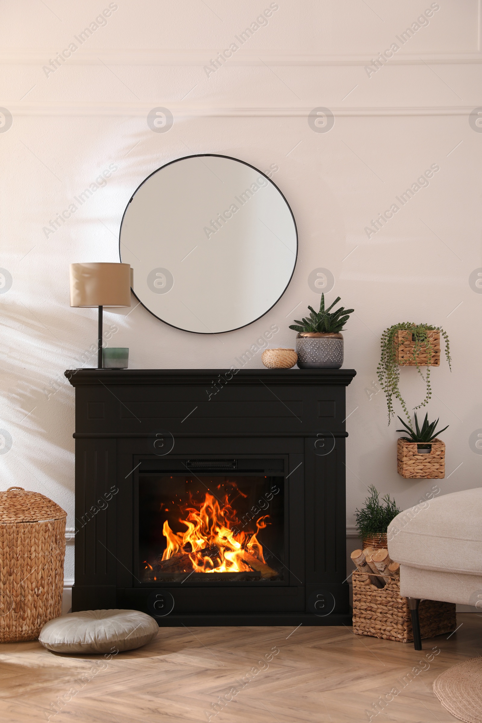 Photo of Stylish room interior with electric fireplace and beautiful decor elements