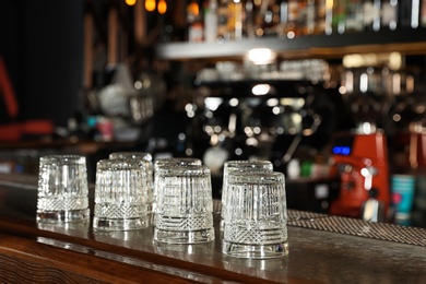 Photo of Empty clean glasses on counter in modern bar