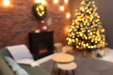 Photo of Blurred view of beautiful Christmas tree with lights in living room