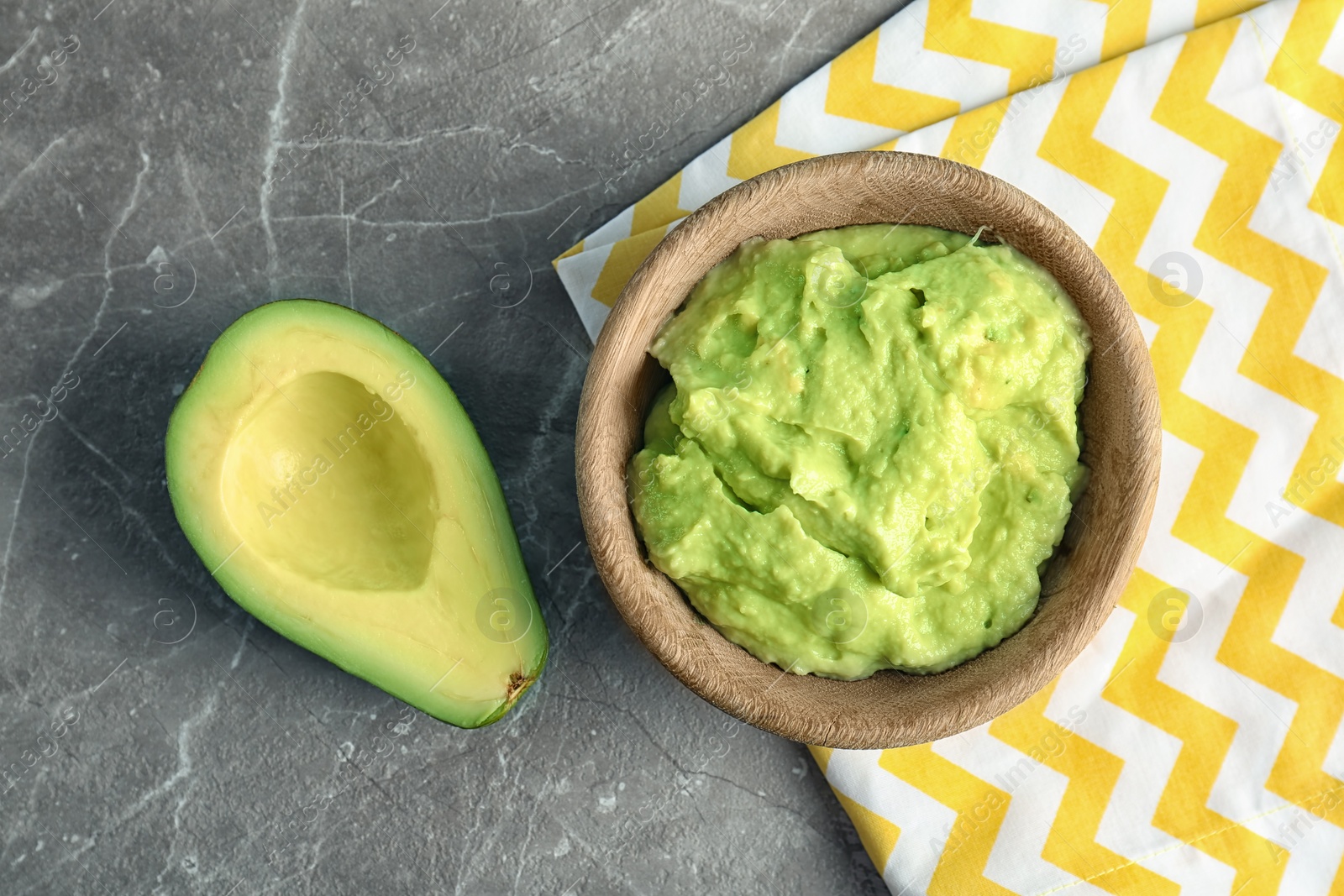 Photo of Flat lay composition with guacamole and ripe avocado on grey background