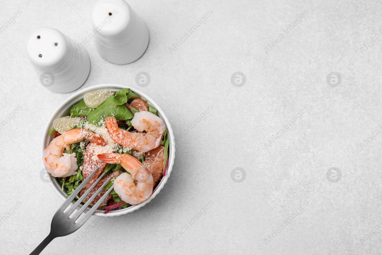 Photo of Delicious salad with pomelo, shrimps and tomatoes on white table, flat lay. Space for text