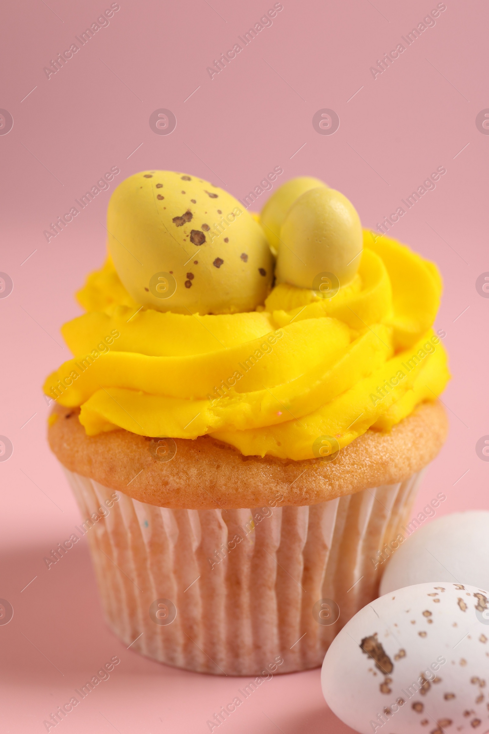 Photo of Tasty cupcake with Easter decor on pink background, closeup