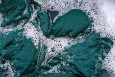 Photo of Garment in suds, top view. Hand washing laundry