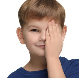 Little boy covering his eye on white background