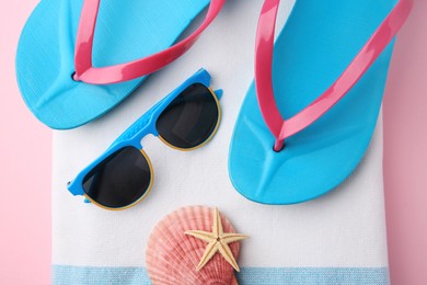 Photo of Flat lay composition with beach accessories on pink background