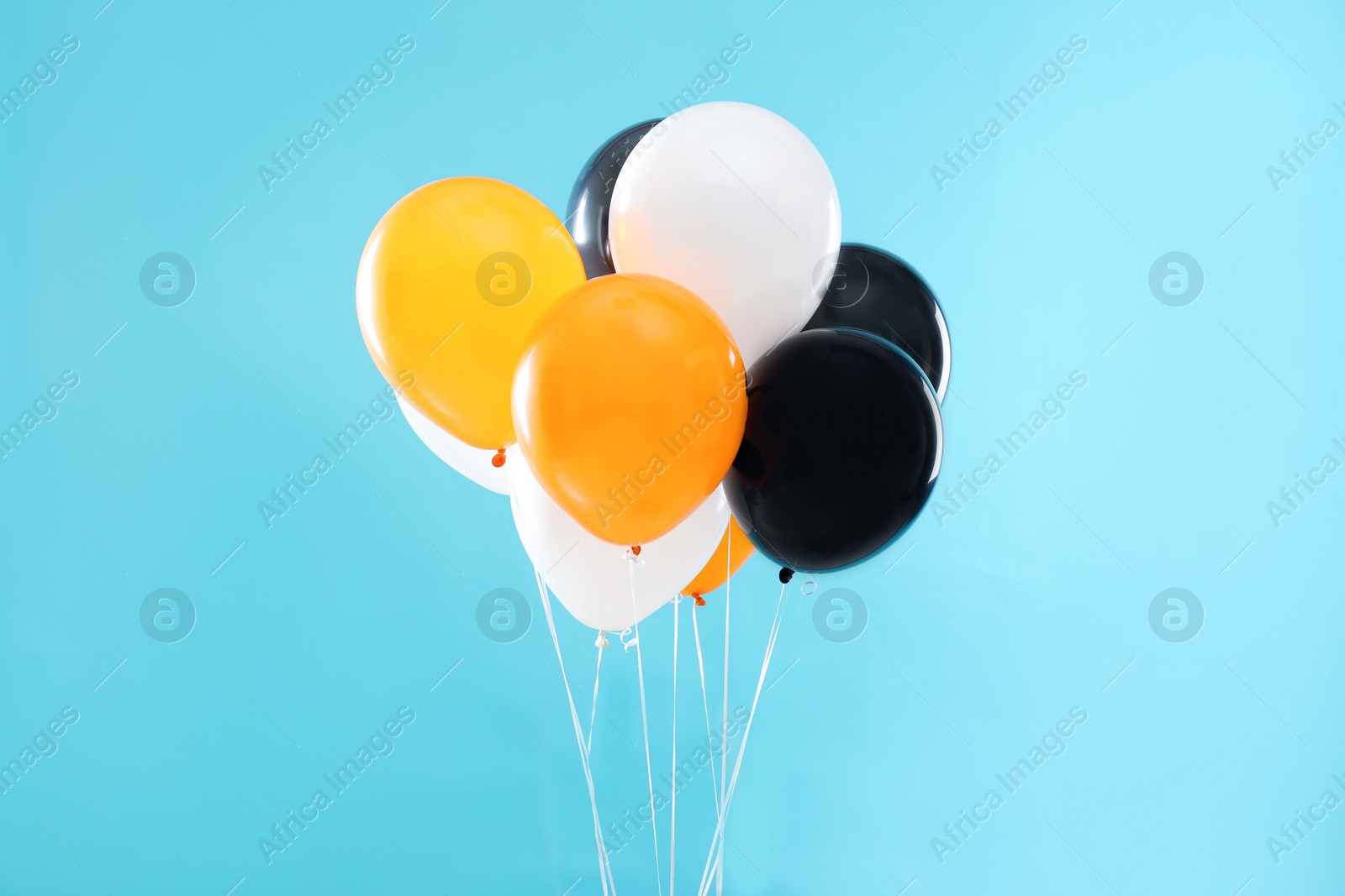 Photo of Colorful balloons on blue background. Halloween party