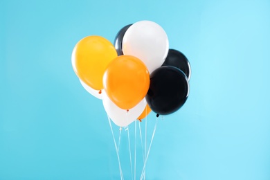 Colorful balloons on blue background. Halloween party