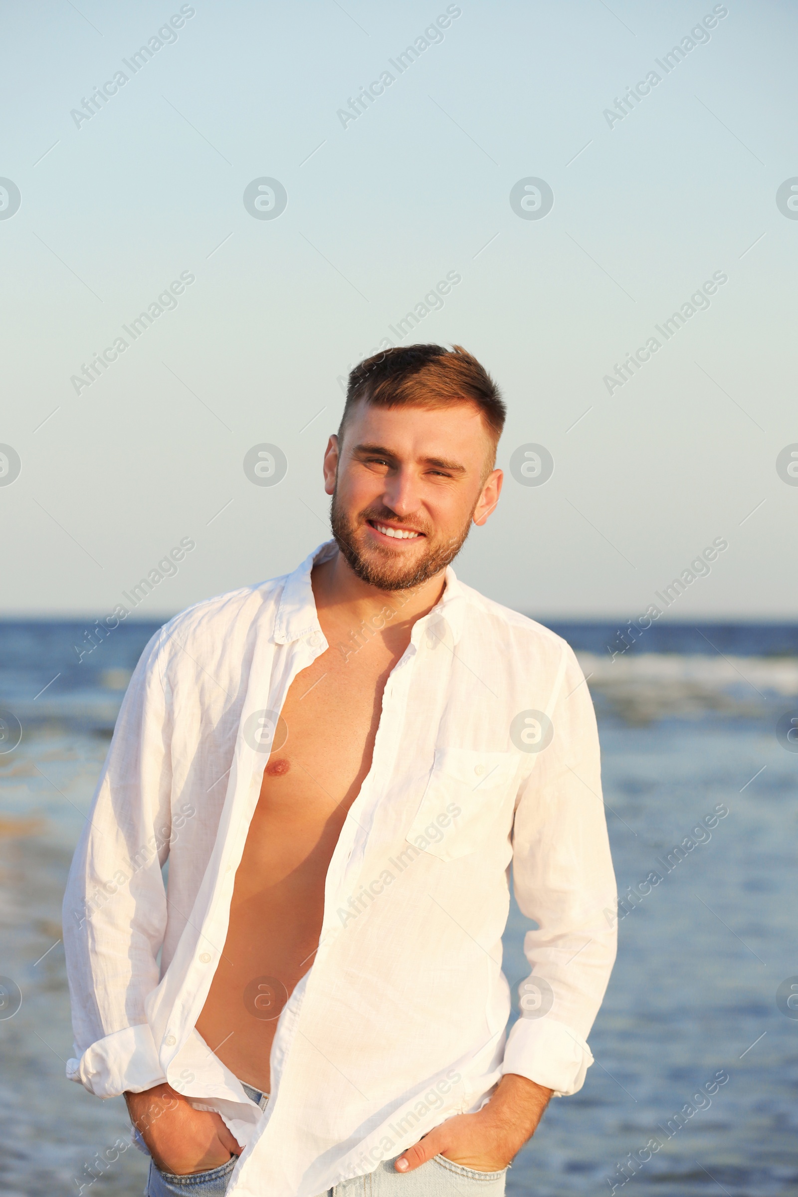 Photo of Young man enjoying sunny day on beach