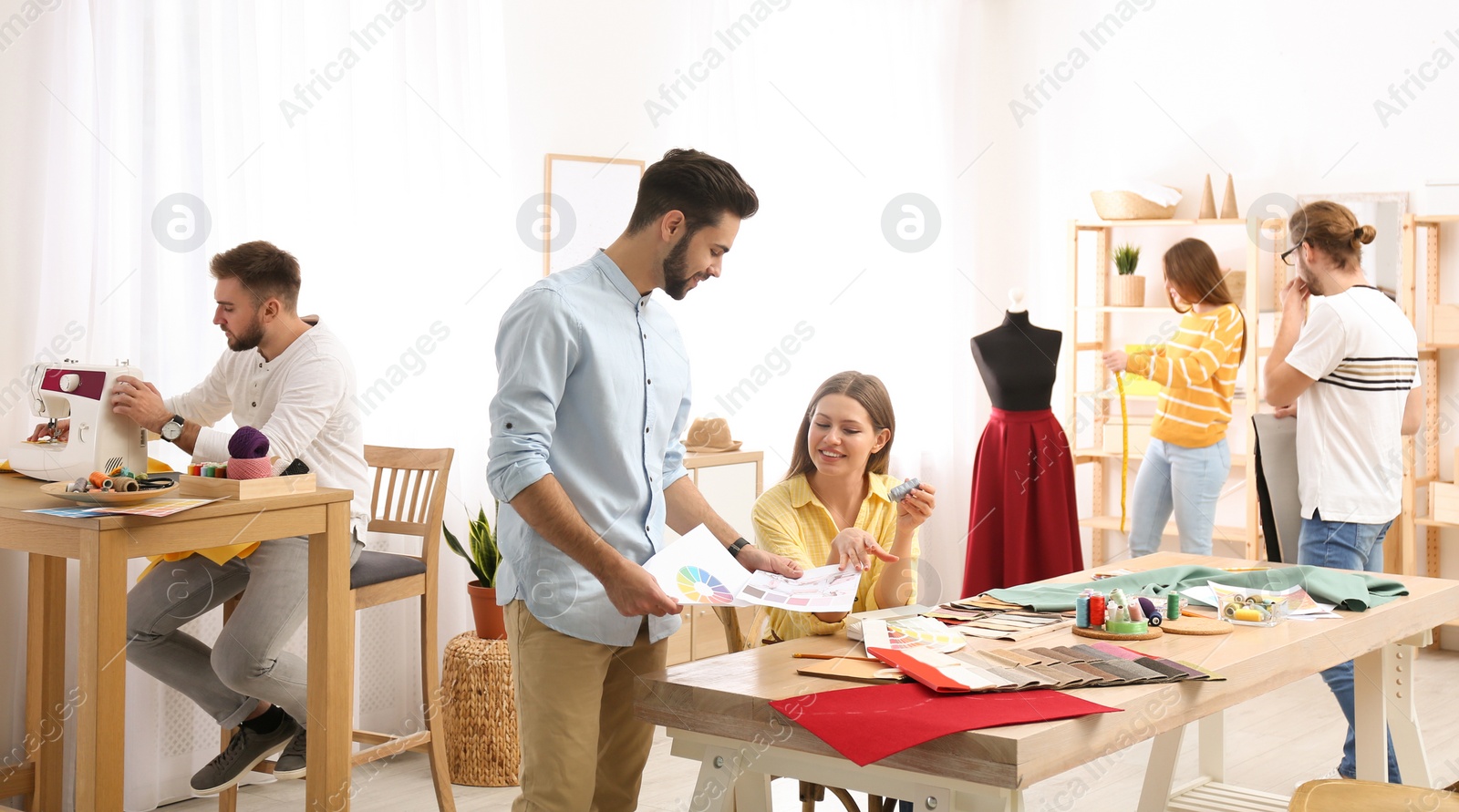 Photo of Fashion designers creating new clothes in studio