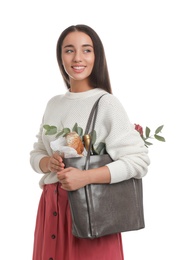 Young woman with leather shopper bag on white background