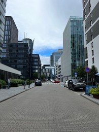Photo of WARSAW, POLAND - JULY 11, 2022: Beautiful view of modern buildings and cars on city street