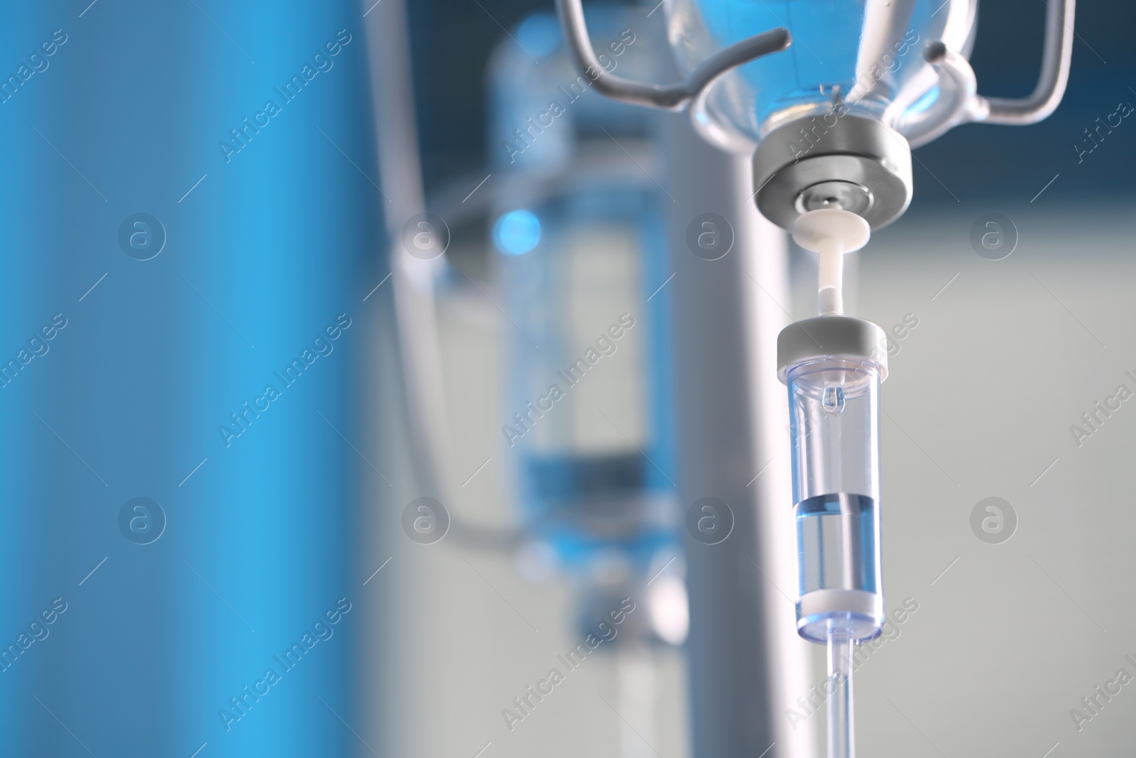 Photo of IV drip against blurred background, space for text