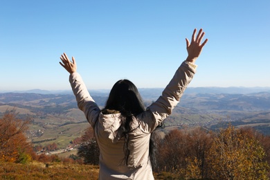 Photo of Woman in warm clothes enjoying mountain landscape