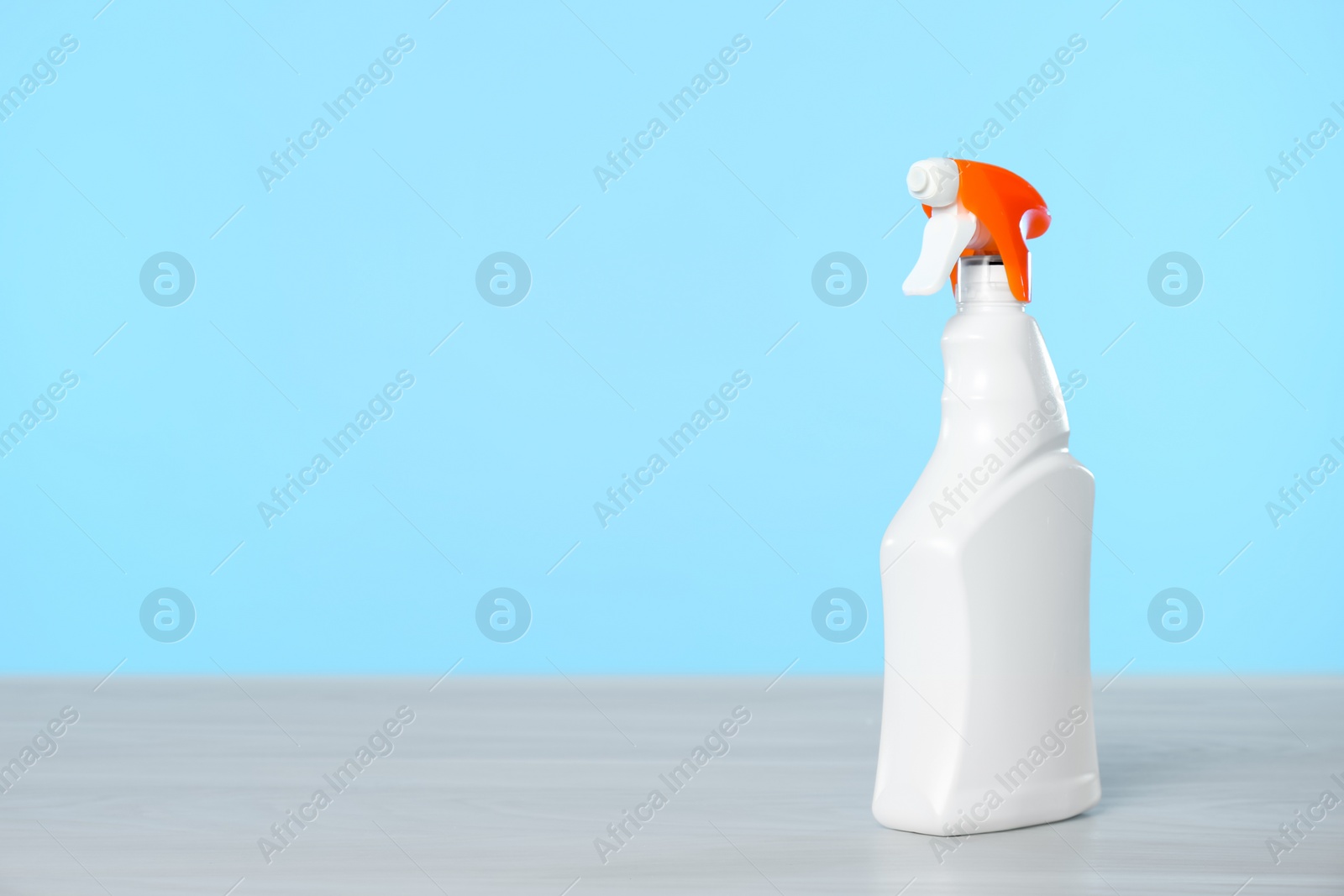 Photo of Bottle of cleaning product on light table. Space for text