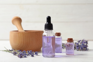 Photo of Composition with natural cosmetic products and lavender flowers on white wooden table