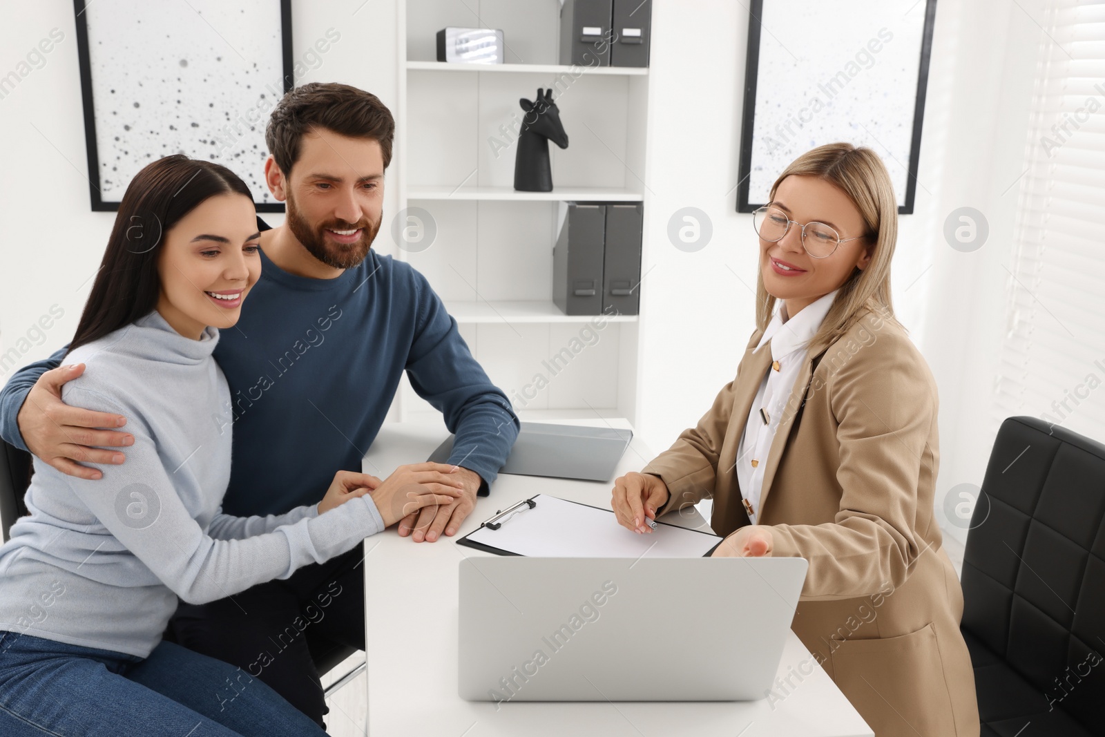 Photo of Real estate agent consulting couple in office