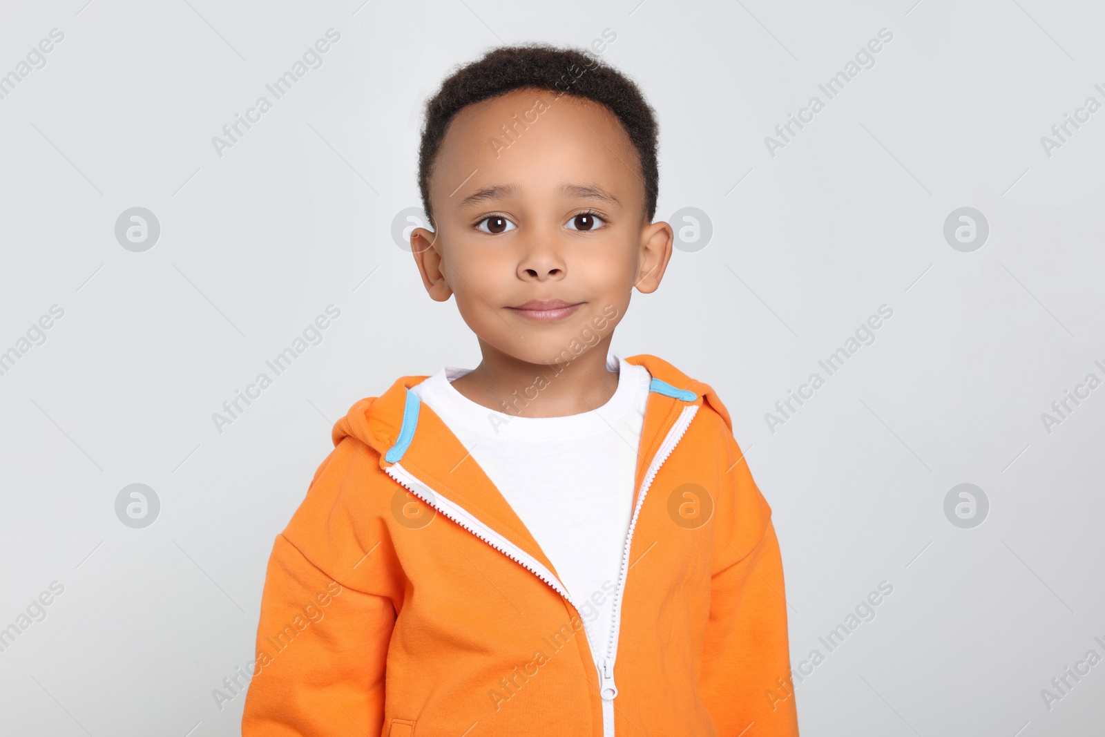 Photo of Portrait of cute African-American boy on light grey background