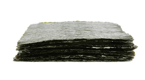 Photo of Stack of dry nori sheets on white background
