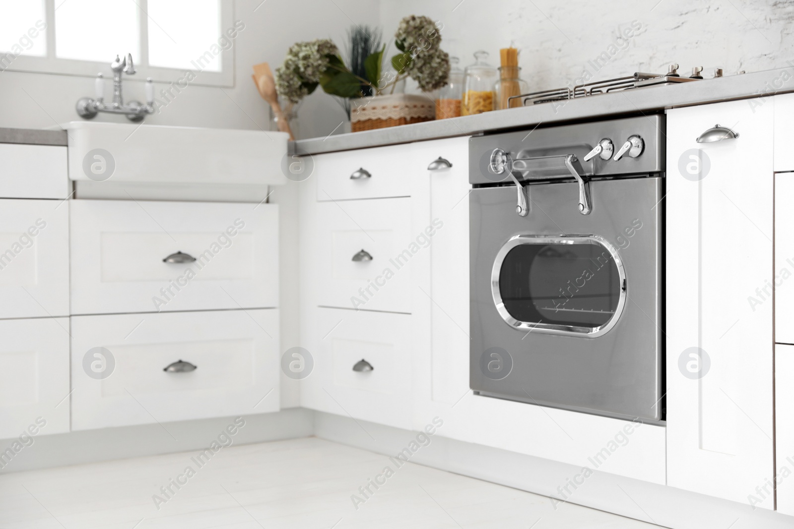 Photo of New modern oven in stylish kitchen. Cooking appliance