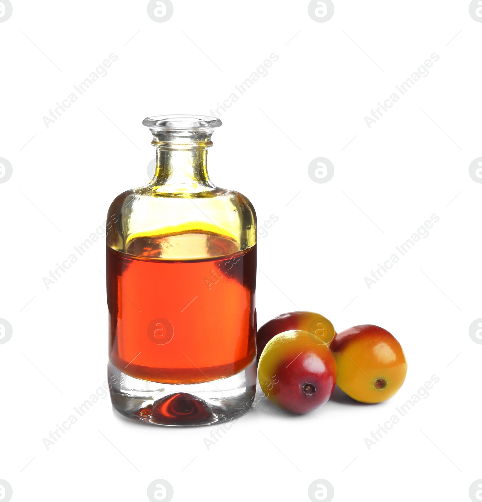 Photo of Palm oil in glass bottle and fruits isolated on white