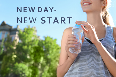 Text New Day - New Start and sporty woman with bottle of water outdoors