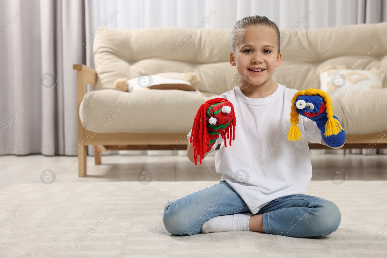 Photo of Happy daughter with funny sock puppets playing at home, space for text