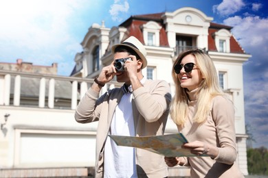 Photo of Couple of tourists taking picture on beautiful city street