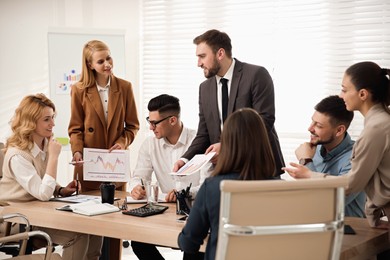 Photo of Businesspeople having meeting in office. Management consulting