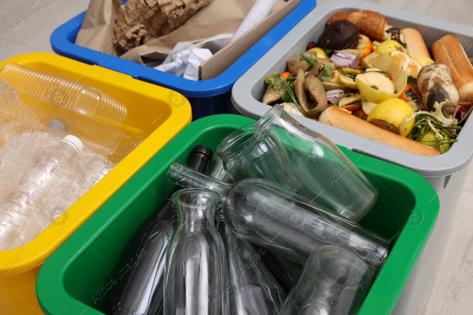 Photo of Garbage sorting. Full trash bins for separate waste collection indoors, closeup