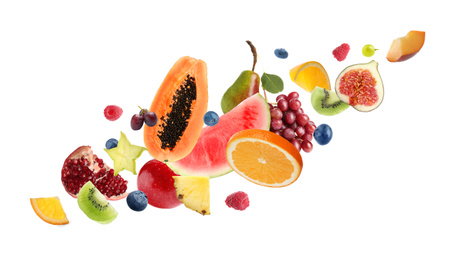 Image of Set of different cut fresh fruits and berries on white background