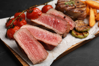 Photo of Delicious sliced beef medallion on table, closeup