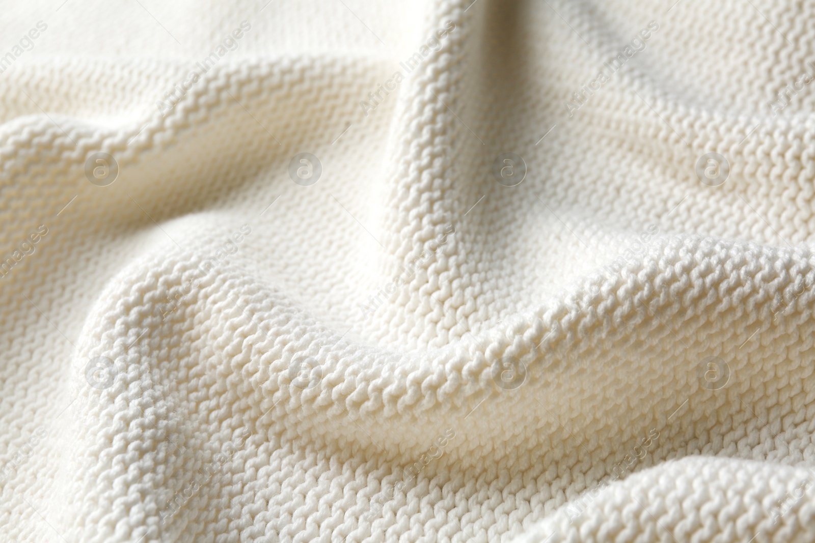 Photo of Beautiful white knitted fabric as background, closeup