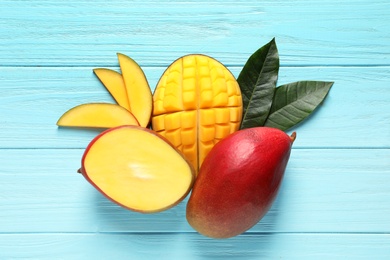 Flat lay composition with mango on color wooden background