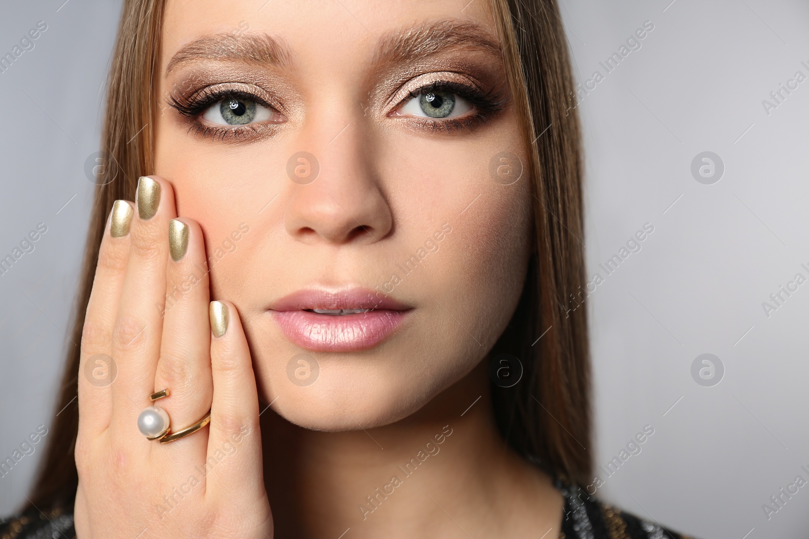 Photo of Beautiful woman with stylish nail polish on grey background