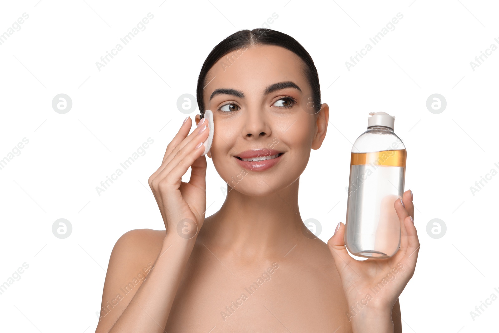 Photo of Beautiful woman removing makeup with cotton pad on white background