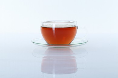 Aromatic tea in glass cup isolated on white