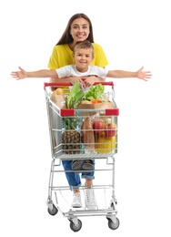 Photo of Mother and son with full shopping cart on white background