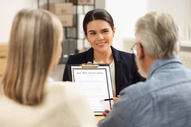 Photo of Notary showing senior man where to sign Last Will and Testament in office