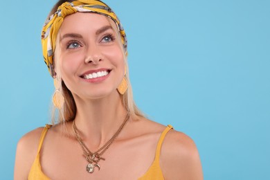 Photo of Portrait of happy hippie woman on light blue background. Space for text