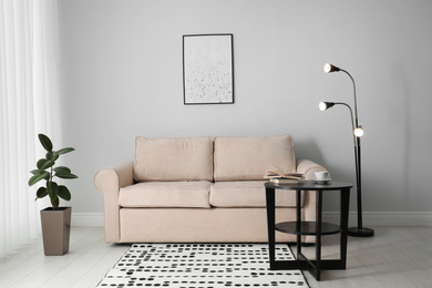 Photo of Modern comfortable sofa in stylish home interior