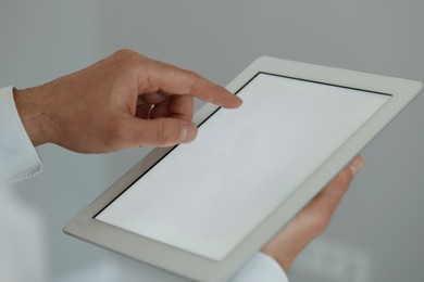 Closeup view of man using new tablet indoors