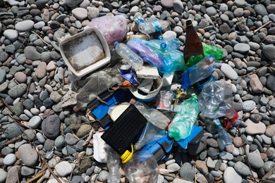 Photo of Pile of garbage on stones outdoors, top view. Environmental Pollution concept