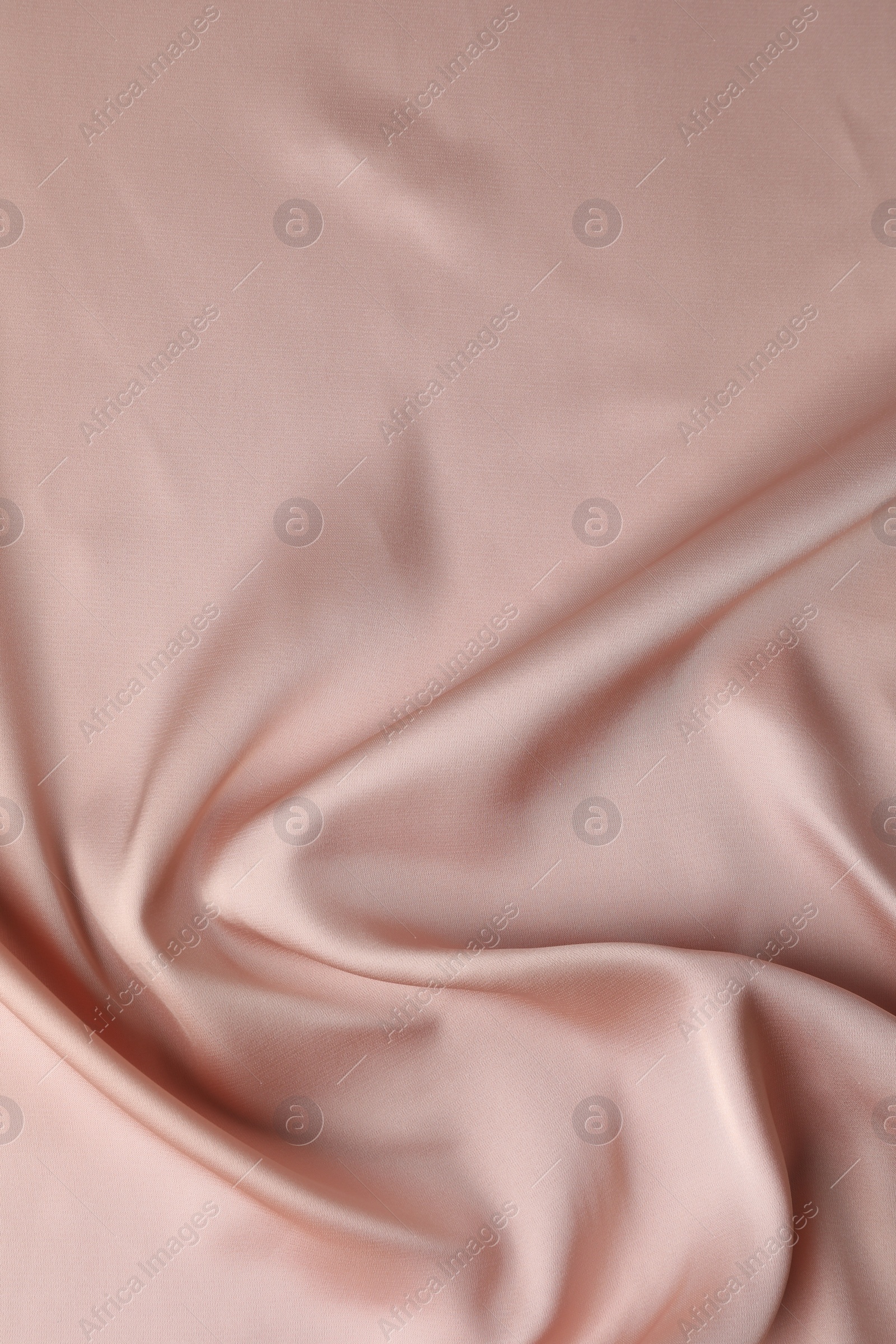 Photo of Crumpled pink silk fabric as background, top view