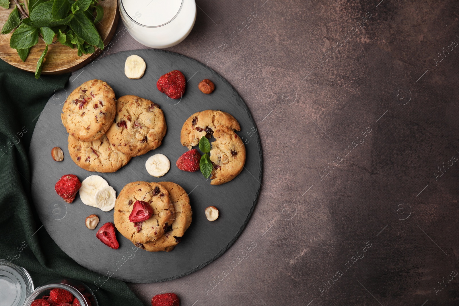 Cookies with freeze dried fruits, mint and nuts on grey table, flat lay. Space for text Photo of Cookies with freeze dried fruits, mint and nuts on grey table, flat lay. Space for text